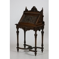 A carved oak Ladies Bureau, in the Renaissance style, the three-quarter gallery with a shell crest a... 