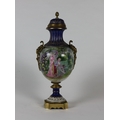 A Serves style brass mounted porcelain Vase and cover, decorated with a garden scene with couple app... 