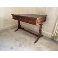 A Regency style three drawer mahogany Dressing Table, raised on reeded standards and four sabre legs... 