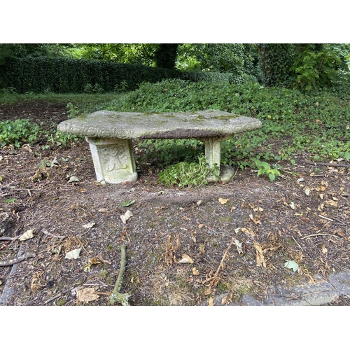 102 - Two similar composition Garden Benches, with curved rectangular seat on two circular plinths, 53'' (... 