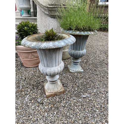 106 - A set of 4 heavy cast iron Garden Urns, each with egg and dart moulded folded rim and ribbed body on... 