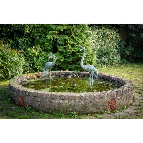 115 - A fine pair of cast bronze Fountain or Pond Figures, modelled as standing Flamingos, one facing forw... 