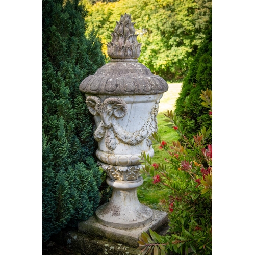 140 - A massive pair of 19th Century composition stone Garden Urns and Covers, each cover with a flame fin... 