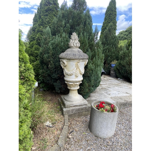 140 - A massive pair of 19th Century composition stone Garden Urns and Covers, each cover with a flame fin... 