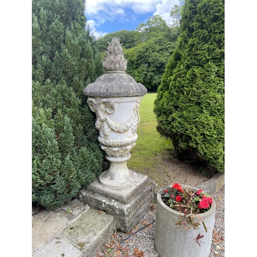 140 - A massive pair of 19th Century composition stone Garden Urns and Covers, each cover with a flame fin... 