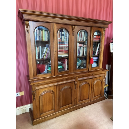 153 - A Victorian style mahogany Library Bookcase, with moulded pediment above four arched and glazed door... 