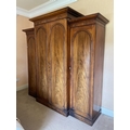 A fine Victorian breakfront Wardrobe, with raised centre and moulded cornice above four arched doors... 
