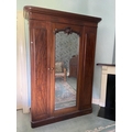 A Victorian mahogany mirror door Wardrobe, with moulded pediment and fitted interior on a plinth bas... 