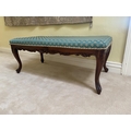 An oblong mahogany Window Stool, with padded seat covered in green shell pattern fabric on four moul... 