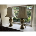 An attractive pair of faux marble and brass Table Lamps, with ivory shades, 30'' (76cms). (2)... 