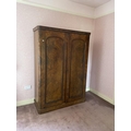A Victorian figured walnut Wardrobe, with arched panel doors on plinth base, 81'' x 55'' (206cms x 1... 