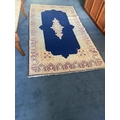 A good Persian Rug, with floral centre medallion on a dark blue ground inside a wide floral border, ... 