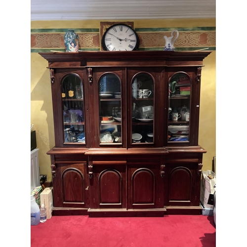 632 - A Victorian style four door breakfront mahogany Bookcase, with moulded pelmet over arched glazed doo... 