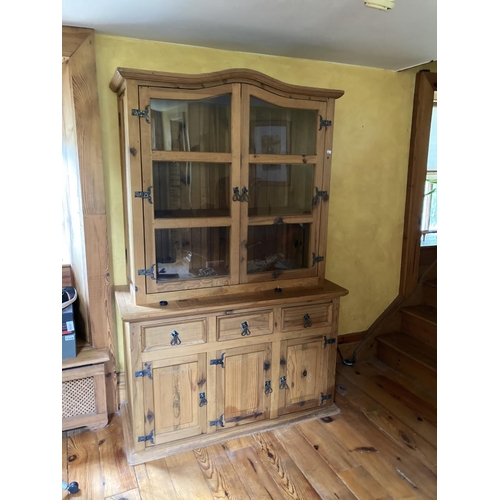 634 - A pine Kitchen Cupboard, with arched top, glazed doors, on a base with drawers and presses, approx. ... 