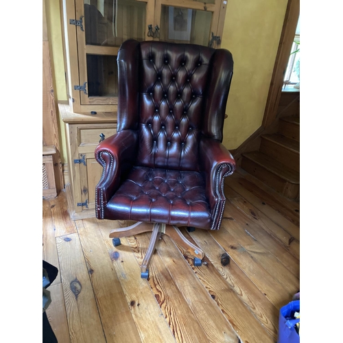 635 - A leather Georgian style high back swivel Armchair, covered in red deep button hide. (1)... 