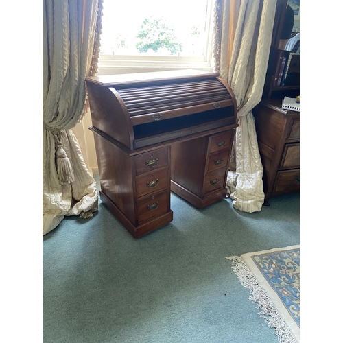 73 - An Edwardian walnut pedestal cylinder Desk, with tambour front on two pedestals each with three draw... 