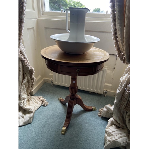 76 - A circular Regency style mahogany rosewood banded Occasional Drum Table, on tripod base, 24'' (61cms... 