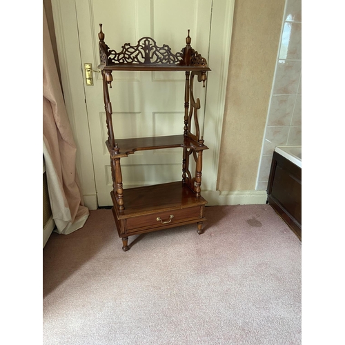 80 - A three tier mahogany Whatnot, with three-quarter openwork gallery with base drawer on turned legs, ... 