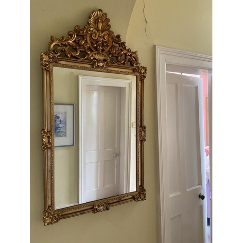 99 - An attractive gilt Wall Mirror, in the 18th Century style, with ornate pediment with shell crest, 48... 