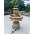 A very attractive composition stone Garden Fountain, with basket of fruit finial above four lion mas... 