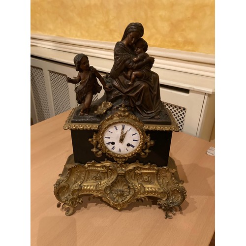 239 - A French gilt metal mounted and polished black marble Mantle Clock, with silk suspension movement an... 