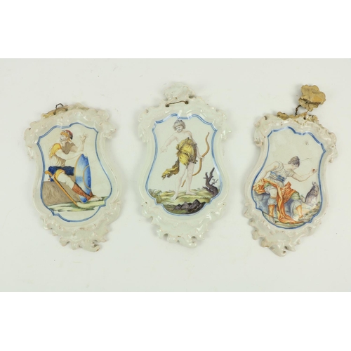 114 - A set of 3 Spanish white enamelled earthenware Wall Plaques by Alcora Factory, c. 1755, the cartouch... 