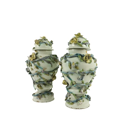 124 - A pair of 18th Century Continental Faience flower encrusted Vases and Covers, each of baluster form,... 