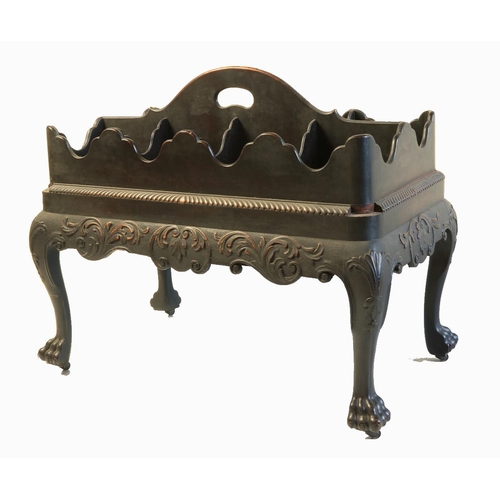 An important fine mid-18th Century Irish mahogany Decanter Stand, with arched saw cut centre handle and eight decanter slots, each with shaped dividers and sides, above a gadroon moulded edge and all round frieze with leaf sprays and "C" scrolls, raised on four leaf carved cabriole legs terminating in lion paw feet with small brass castors, 22 1/2" (57cms) high x 29" (74cms) wide x 16" (41cms) deep. (1)