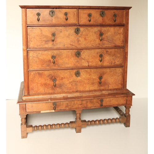 448 - An early 18th Century figured walnut Chest on Stand, the crossbanded top with moulded edge, over two... 