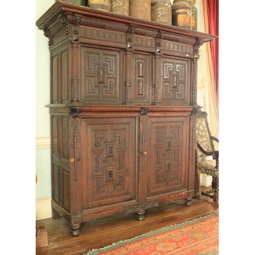 558 - An 18th Century oak Armoire, probably German, the moulded cornice above a frieze with grotesque mask... 