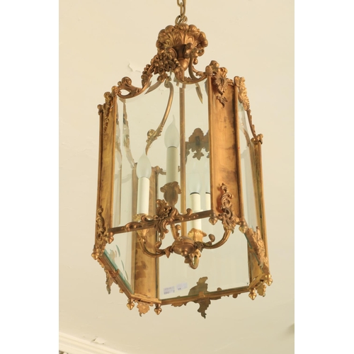 575 - A very fine pair of rococo style French brass Hall Lanterns, each with four glazed panels, united by... 