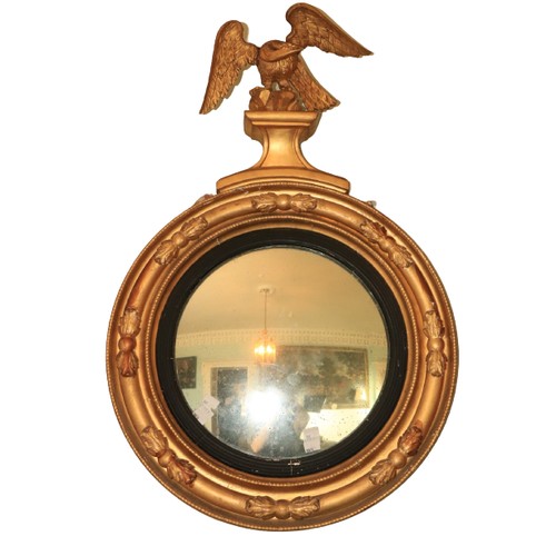 567 - A fine quality early 19th Century circular convex giltwood Mirror, with carved eagle surmounted, and... 