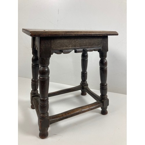 529 - An early 18th Century oak Joiners Stool, the plain seat with sloped reeded edge,, and serrated ends,... 