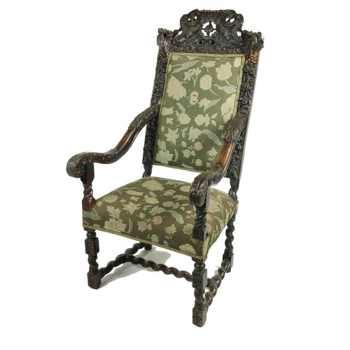 555 - An early 19th Century Cromwellian style walnut high back Armchair, the shell and leaf crested top fl... 