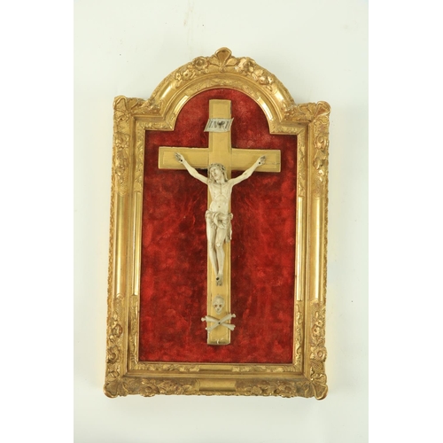 820 - A fine early carved ivory Corpus Christi, mounted on a giltwood cross with ivory skull and cross bon... 