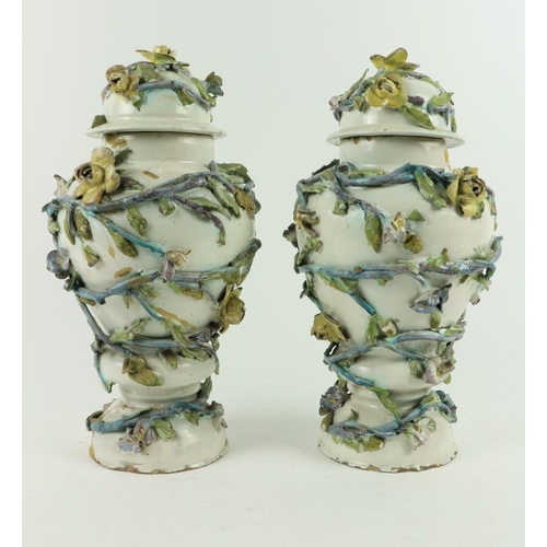 124 - A pair of 18th Century Continental Faience flower encrusted Vases and Covers, each of baluster form,... 