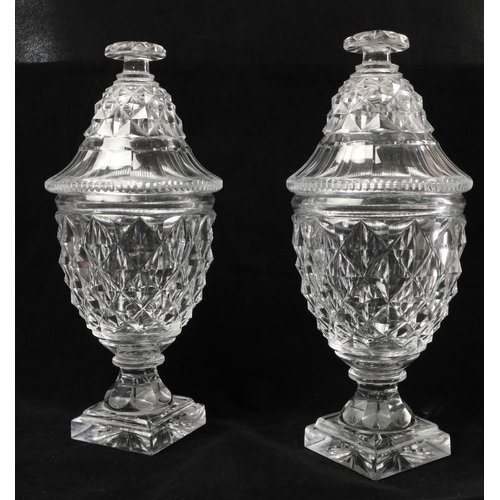 137 - A quality pair of early 19th Century Irish cutglass pineapple shaped Jars and covers, on square base... 