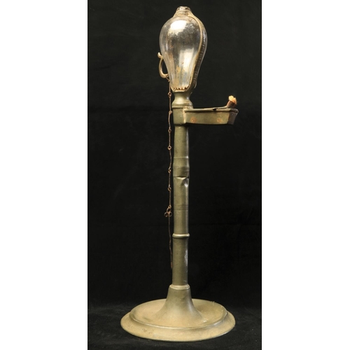 139 - An 18th Century pewter Desk Light, with original glass bulbous oil container and finger handle on a ... 