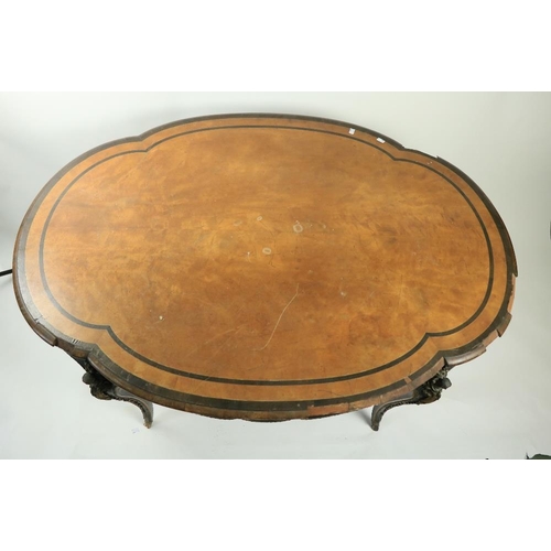 165 - An oval serpentine shaped French Centre Table, with ornate brass mounts and ebonised crossbanding on... 