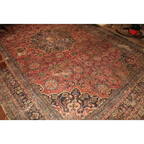 191 - A large antique Persian Carpet, with all over floral pattern and centre medallion panel of dark blue... 