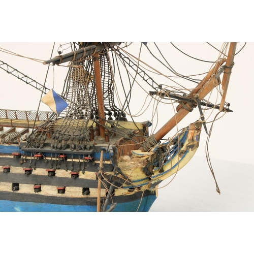 212 - A painted wooden Model of HMS Victory, with three masts and various flags, 17