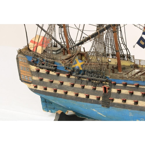 212 - A painted wooden Model of HMS Victory, with three masts and various flags, 17