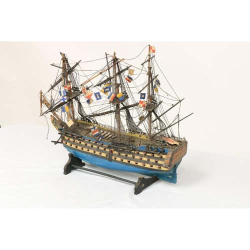 212 - A painted wooden Model of HMS Victory, with three masts and various flags, 17