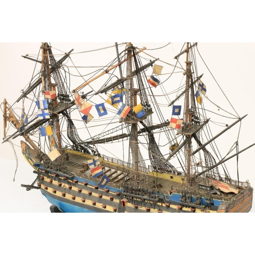 212 - A painted wooden Model of HMS Victory, with three masts and various flags, 17