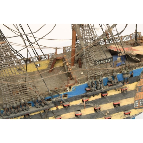 212 - A painted wooden Model of HMS Victory, with three masts and various flags, 17