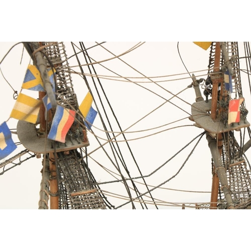 212 - A painted wooden Model of HMS Victory, with three masts and various flags, 17