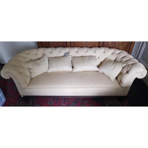 269 - A Victorian Settee, of low proportions, covered in cream deep button fabric on ebonised turned feet,... 