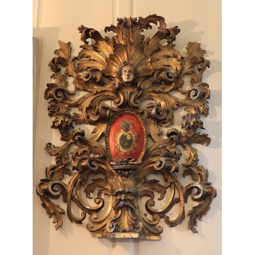 325 - A magnificent 18th Century Baroque carved Armorial Wall Piece, in the rococo style, the crest with s... 