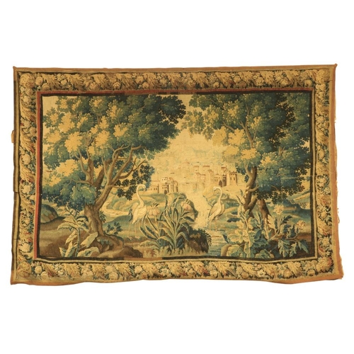 387 - A 17th Century Flemish Verdure Tapestry, with castellated town beyond, trees and exotic birds to the... 