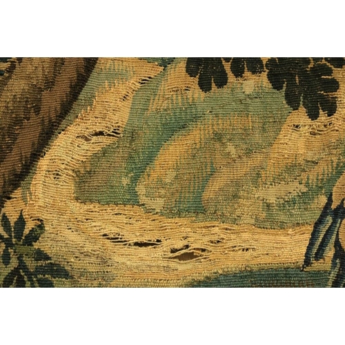 387 - A 17th Century Flemish Verdure Tapestry, with castellated town beyond, trees and exotic birds to the... 